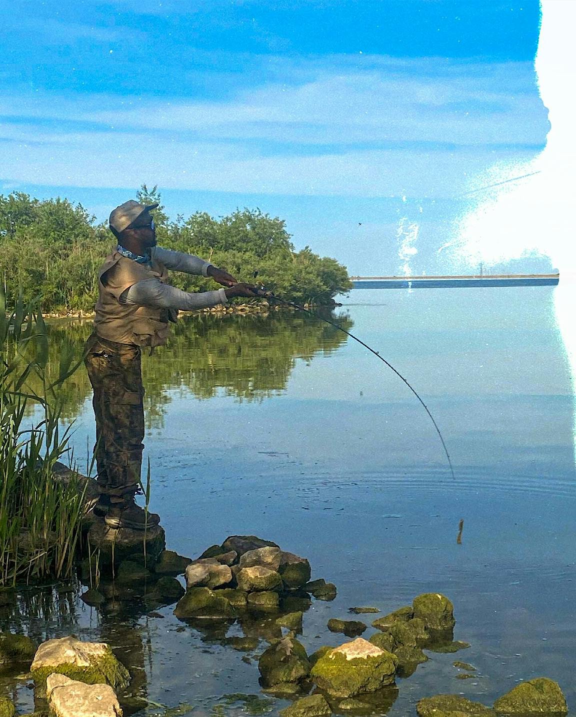 A person fishes in a lake.